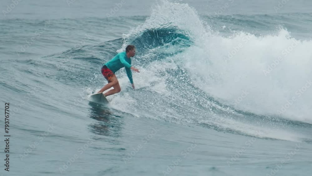 Surfer rides the wave in the Maldives Surfer rides the wave in the Maldives
