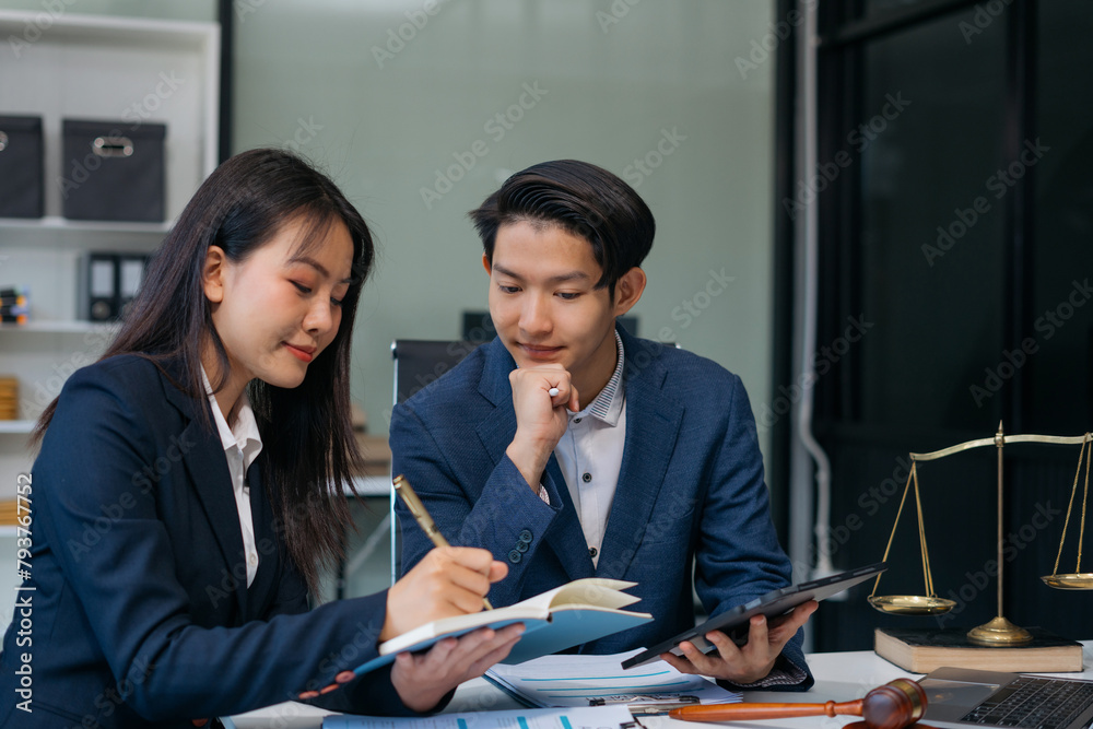Teamwork of business lawyer meeting working hard about legal legislation in courtroom to help their customer. Teamwork of business lawyer meeting working hard about legal legislation in courtroom to help their customer.