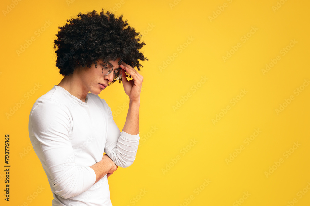 Depressed african man deep in thoughts, touching his forehead Depressed african man deep in thoughts, touching his forehead
