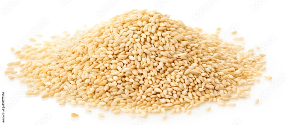 Sesame seeds on a plain white surface Sesame seeds on a plain white surface