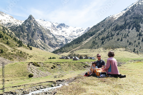 Happy family with one child having a rest during a hiking day around Les granges du Moudang in French Pyrenees.
