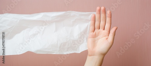 Person holding white plastic bag