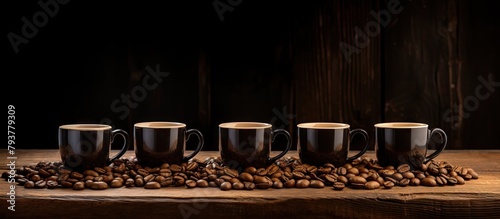 coffee cups and beans on a wooden table
