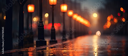 A street illuminated by lights on a rainy evening