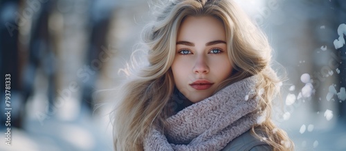 A woman in a jacket and scarf with long blonde hair photo