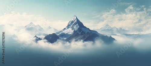 Mountains in the clouds with blue sky and some clouds photo