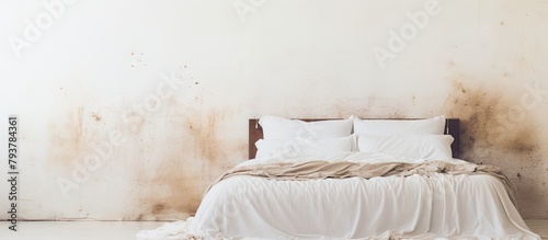 Aged bed with white linens and cushions in a grimy room photo