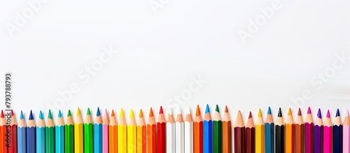 Row of vibrant crayons on a white background