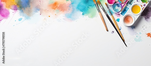 Close-up of paint palette, brushes, and watercolors