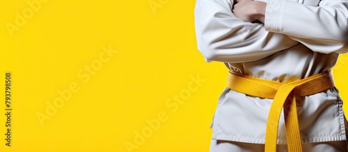 Focused martial artist white outfit yellow belt photo