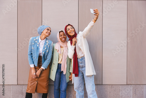 Beautiful muslim girl wearing hijab bonding outdoors photo