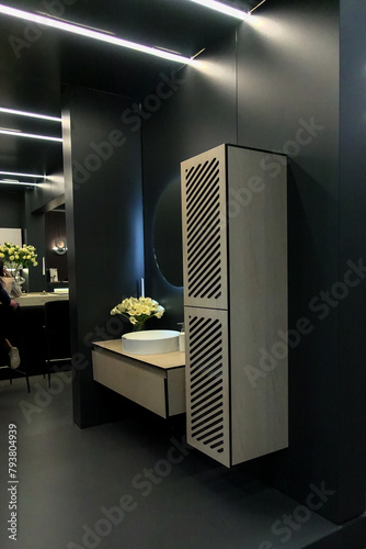 Elegant black room with white washbasin and wall cabinet for bathroom accessories