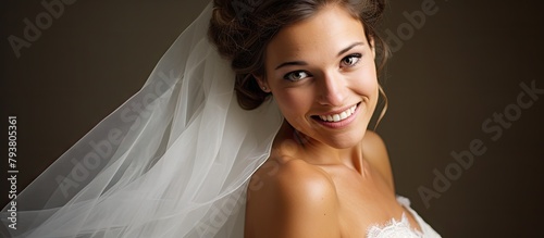 Bride smiles in veil photo