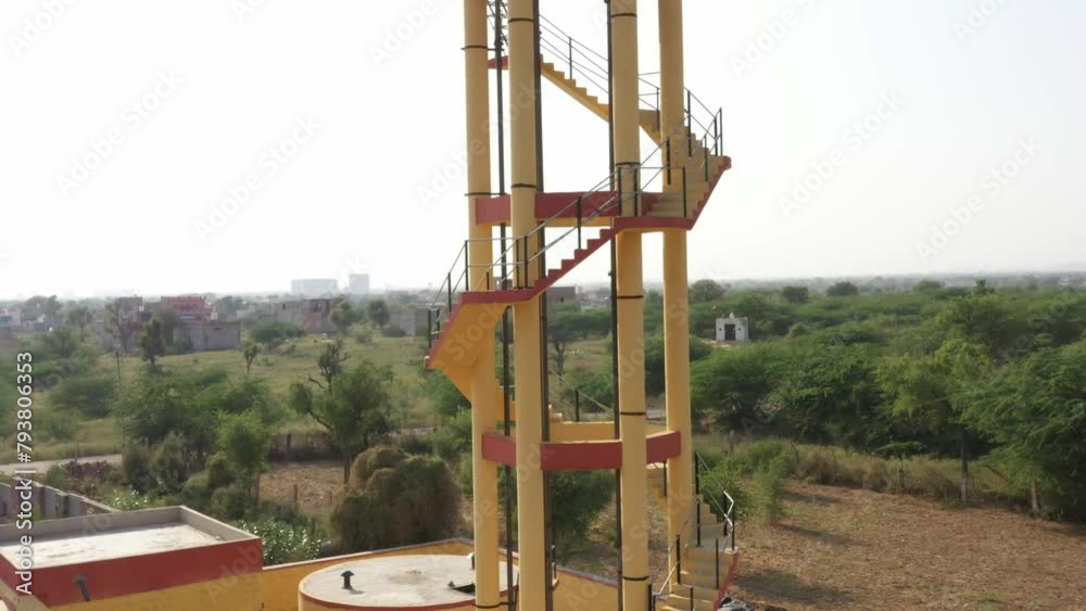 drone shot of Yellow painted water tank tower or Yellow water tank or