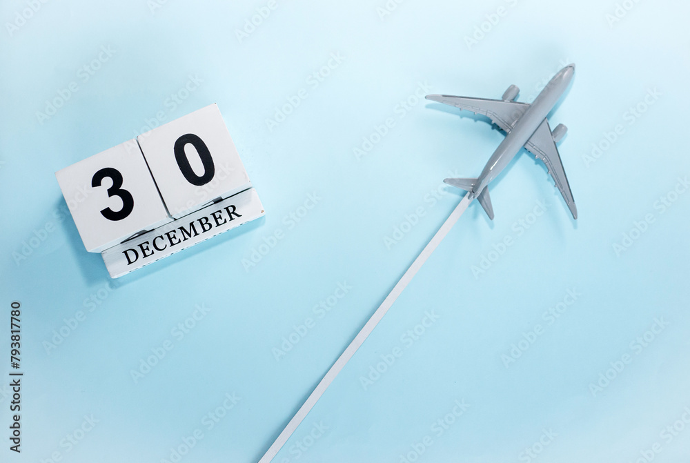 December calendar with number 30. Top view of a calendar with a flying passenger plane. Scheduler. Travel concept. Copy space. December calendar with number 30. Top view of a calendar with a flying passenger plane. Scheduler. Travel concept. Copy space.