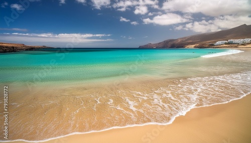 beach with water  Jumping girl on beach. Smilling blonde girl enjoying sandy beach  looking at crystalline sea in Canary Islands. Concept of beach summer vacation with kids.