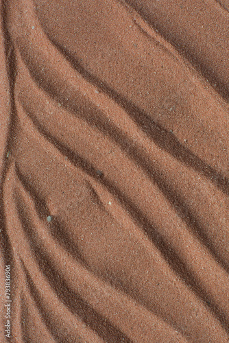 Lines drawn in brown sand background, beautiful sand texture, overhead view of chocolate brown sand, zen pattern drawn in the sand, Top view of fine grain texture