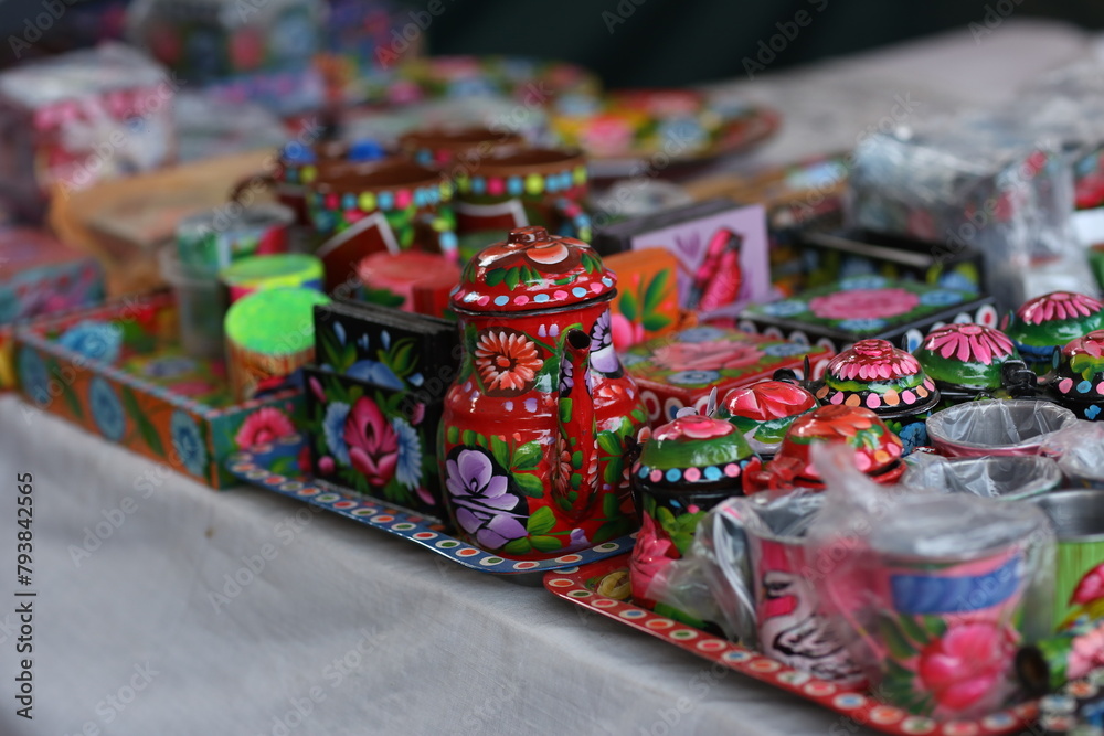 Stack of traditional Plates and handmade ceramics, handmade colorful dishes , Handicraft kettle item, Colorful Handmade Pottery and Ceramics, Souvenir Shop in lok virsa mela Islam
