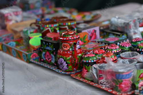 Stack of traditional Plates and handmade ceramics, handmade colorful dishes , Handicraft kettle item, Colorful Handmade Pottery and Ceramics, Souvenir Shop in lok virsa mela Islam
 photo