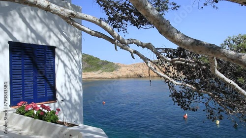 Partial view of the cove with detail of blue window and white walls typical of Mediterranean fishermen's houses. Sa Tuna, Begur, Costa Brava, Catalonia, Spain.