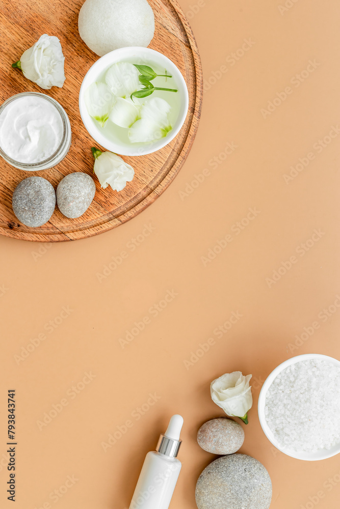 Frame of white cosmetics products and roses flowers, top view Frame of white cosmetics products and roses flowers, top view