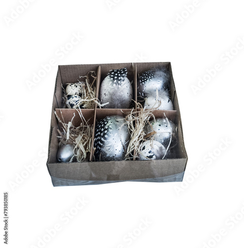 stylish painted Easter eggs in a silver stylized tray with bird feathers