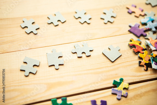 Few mockup puzzles on wooden background. Stay at home concept photo