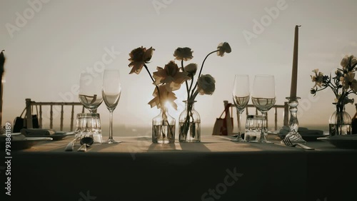Dinner table decoration flowers candles sunset. Romantic wedding dinner outdoor.