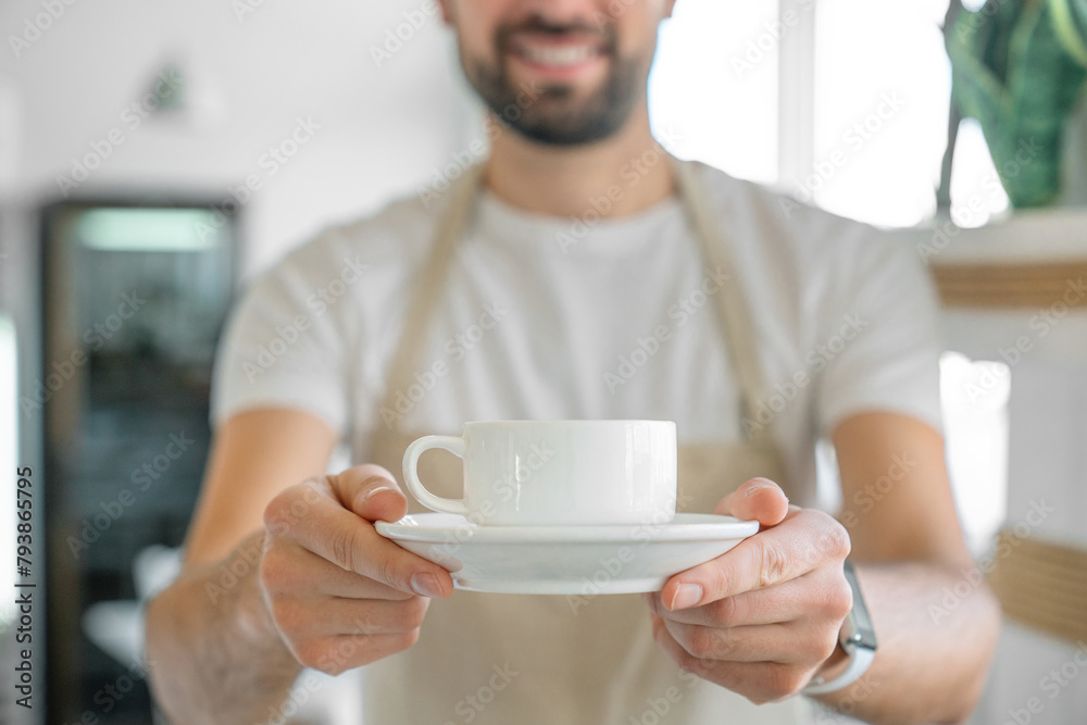 Closeup of barista offering a coffee cup. Coffee shop owner serving coffee. Cropped photo of decaf sugar free non-lactose milk hot beverage cacao chocolate in cafe restaurant