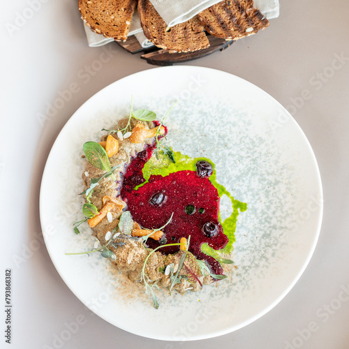 Elegant vegetable pâté with vibrant beetroot coulis and fresh herbs, plated artistically. Culinary excellence with a modern twist. (ID: 793868382)
