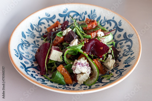 Sumptuous beetroot salad, tangy feta, quinoa sprinkle, in a handcrafted blue-patterned bowl. Vibrant, healthy gastronomy with an artisanal touch. (ID: 793868387)