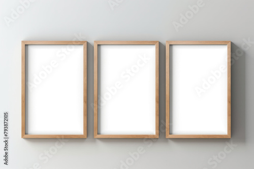 Three empty wooden frames hanging on wall
