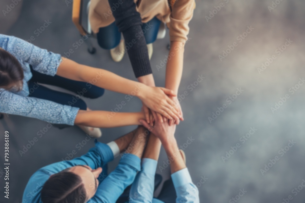 Top view of business people teaming together with hands on top, showing unity and support in the office. Top view of business people teaming together with hands on top, showing unity and support in the office.