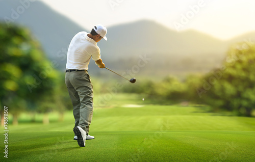 Golfer hitting golf ball with driver to fairway.