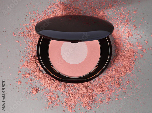 Round pink blusher and crashed eyeshadow for make up. Sample of cosmetic product