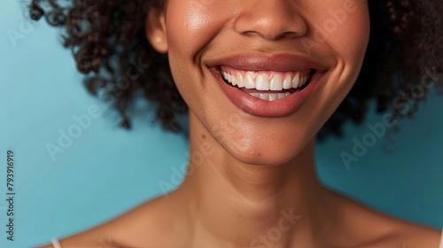 A close-up of a smiling woman with plump lips after cosmetic lip augmentation surgery, radiating confidence and beauty.