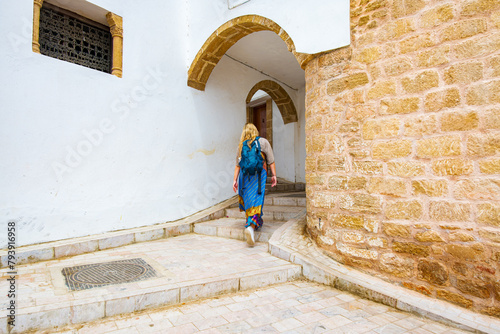 Occidental blonde girl in Kasbah of Udayas fortress in Rabat Morocco. Kasbah Udayas is ancient attraction of Rabat Morocco, near Bou Regreg river.