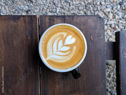 close up glass of coffee on a wooden table in a cafe