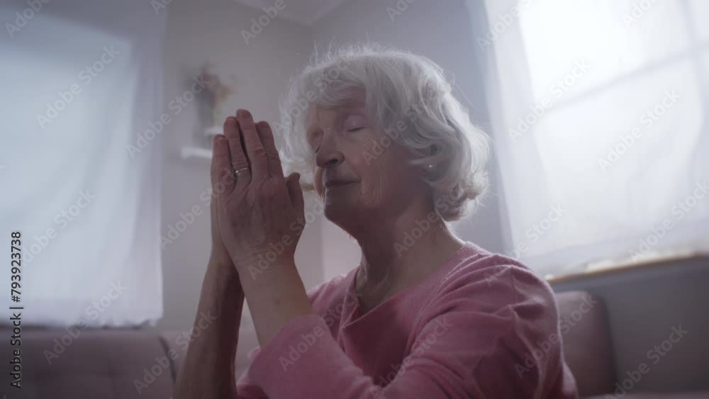 Elderly woman meditates, does yoga at home, finds peace, finds her inner peace, does sport Elderly woman meditates, does yoga at home, finds peace, finds her inner peace, does sport