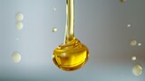 Drop of olive oil or oily cosmetic liquid dripping on a white background