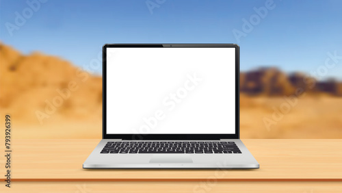 Laptop computer with blank screen on table at landscape mountain blurred background