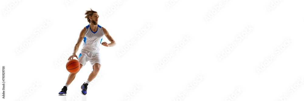 Dynamic image of focused beaded man, basketball athlete in motion with ball, practicing isolated on white background. Concept of sport, competition, active and healthy lifestyle, game. Banner.