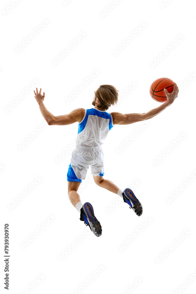 Back view dynamic image of young man, basketball player in motion with ball, scoring goal. practicing isolated on white background. Concept of sport, competition, active and healthy lifestyle, game