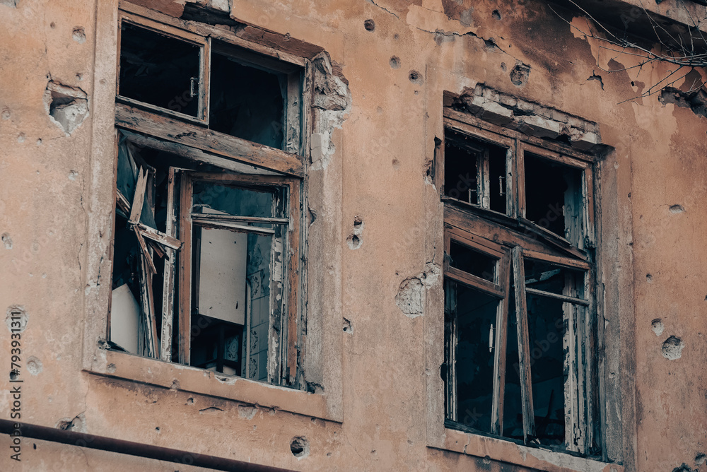 empty windows of a damaged house in Ukraine