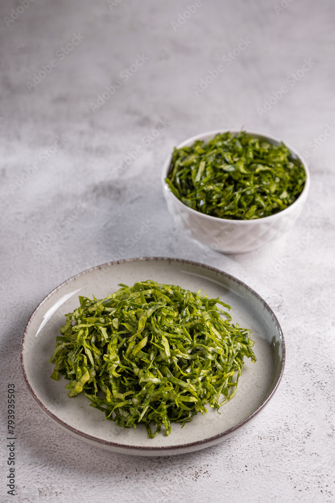 Plate with chopped kale leaves. Green cabbage leaves. Plate with chopped kale leaves. Green cabbage leaves.