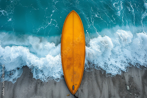 A single yellow surfboard standing on a white sandy beach