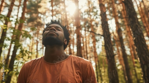 african american man breathing fresh air in the forest nature connection and wellness concept