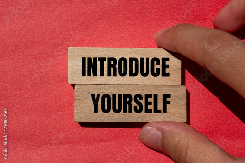 Introduce yourself words written on wooden blocks with red background. Conceptual introduce yourself symbol. Copy space.