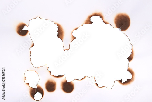 Burnt holes of paper isolated on white background © dule964
