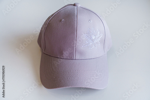 15 Needle Compact Embroidery Machine. Close-up of Cap on embroidery machine. Industrial Embroidery Equipment. Finished lotus embroidery on the cap.